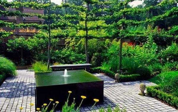 Black water feature in a modern garden