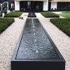 Long black water feature on a drive way